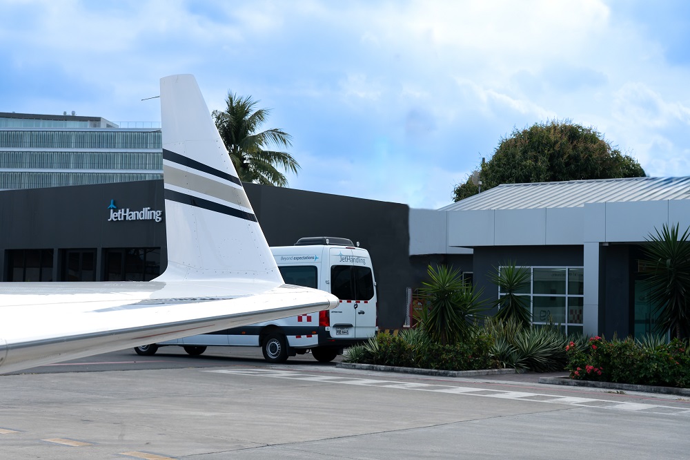 Private jet wing in front of Jethandling aviation operations office facilities