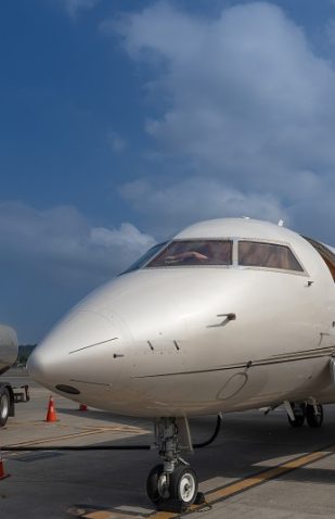 Private jet being refueled with aviation fuel during airport ground operations