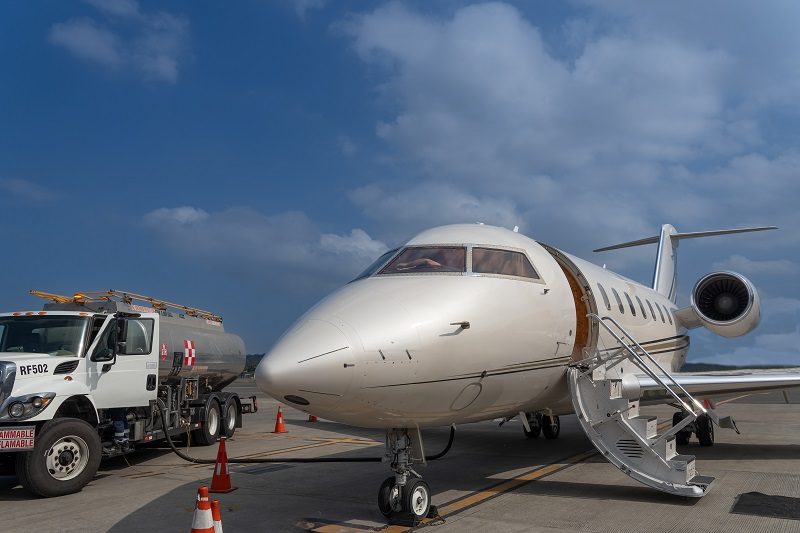 Private jet being refueled with aviation fuel during airport ground operations
