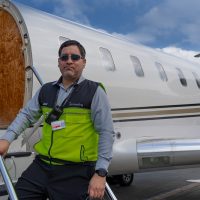 Ground handling staff boarding a private jet during flight preparation