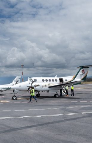 Jethandling ground handling staff coordinating private jet operations on the runway